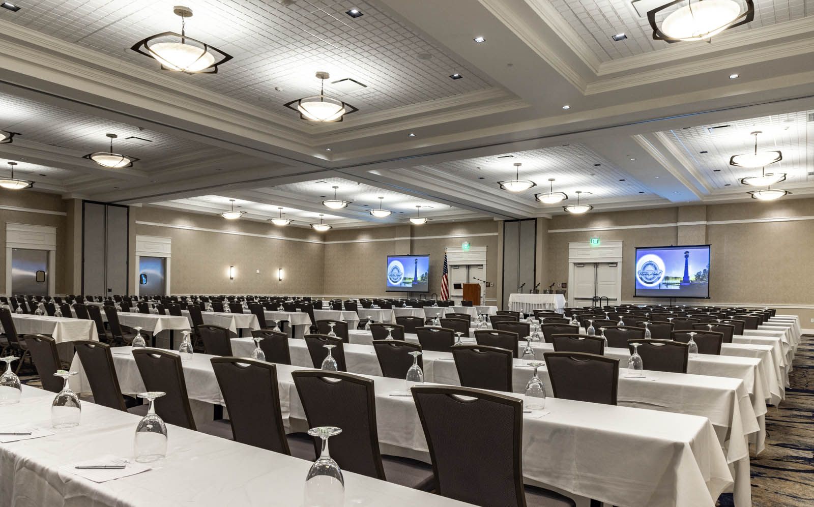 A large meeting facility with rows of empty chairs ready for a corporate meeting