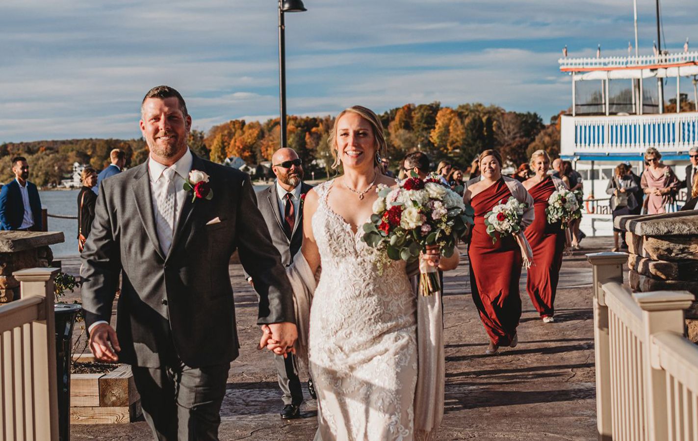 A photo of a happy wedding couple walking along the island at Chautauqua Harbor Hotel