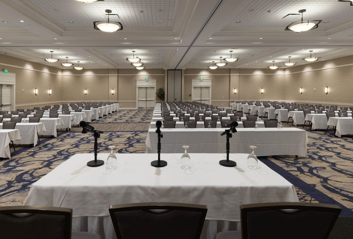 A large conference hall with rows of empty chairs ready for a meeting