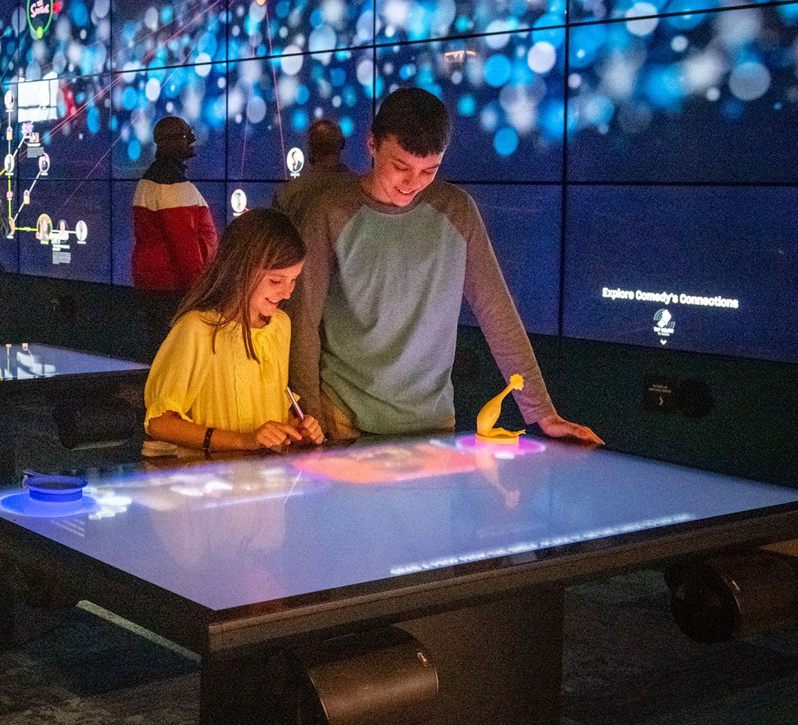 Two children exploring the exhibits at the National Comedy Center in Jamestown NY