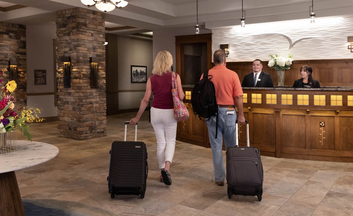 A couple checking in at the lobby of the Chautauqua Harbor Hotel