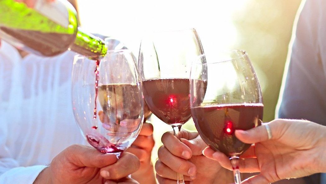 Several couples clinking wine glasses on the Lake Erie Wine Trail